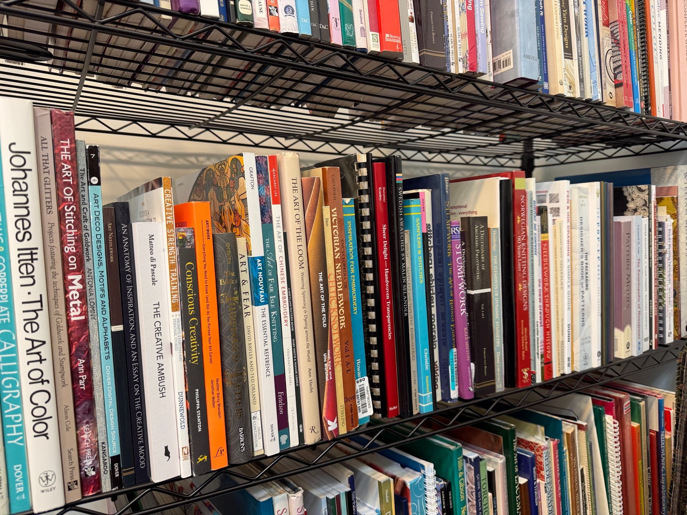 Library shelves of embroidery, calligraphy, and design books